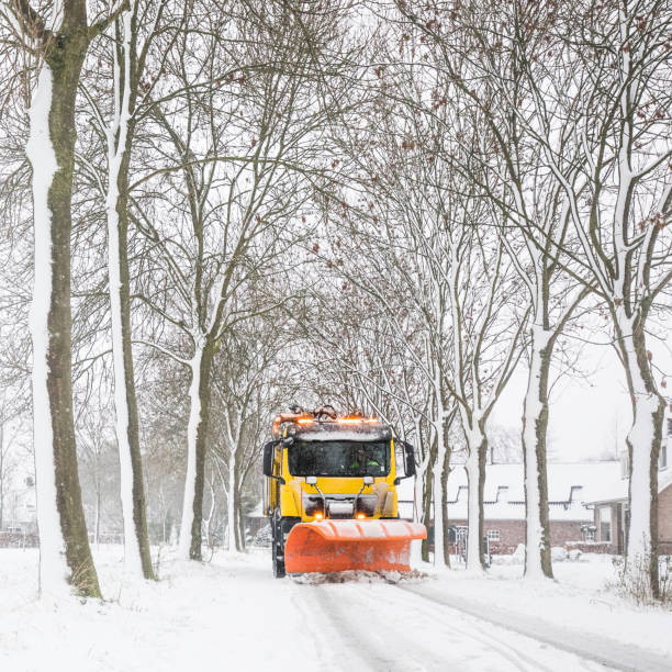 istock snowplow clearing road, winter service 1052940508
