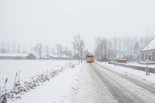 istock snowplow clearing road, winter service 1052940514
