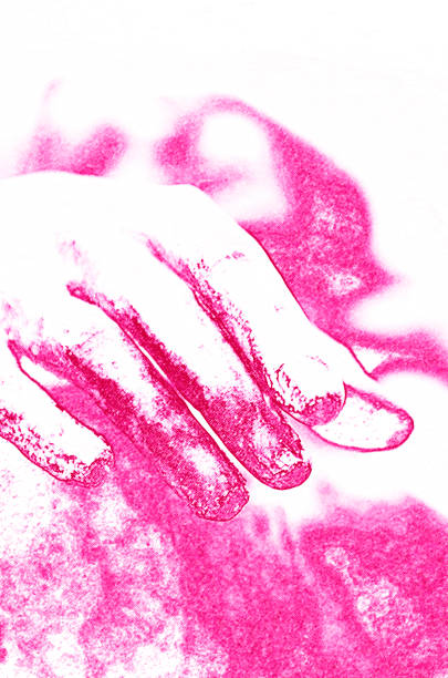 Closeup of a woman's hand is hanging by her side
