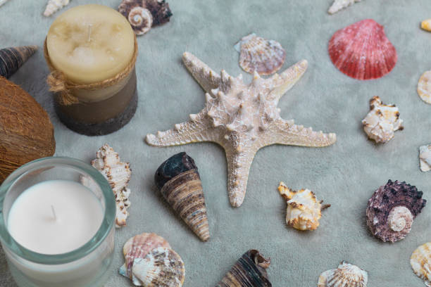 istock Christmas accessories, candles and seashells on a gray background 1052965310
