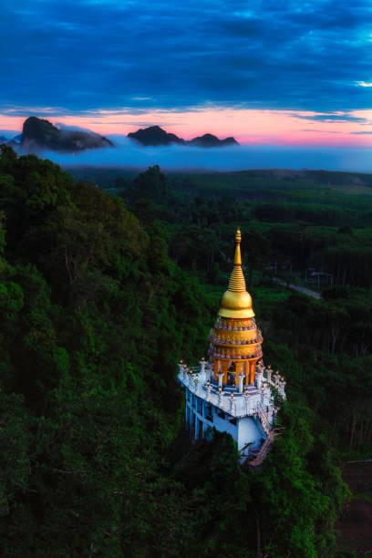 Beautiful pagoda at sunrise on the top Beautiful pagoda at sunrise on the top  with fog at Khao Na Nai Luang Dharma Park,Surat Thani province,Thailand. dharma stock pictures, royalty-free photos & images