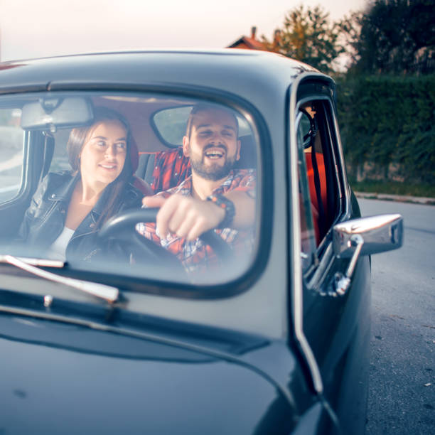 istock Joyful young couple smiling while riding in car 1052967214