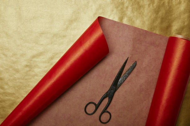 istock top view of scissors on red and golden wrapping papers background 1052974262