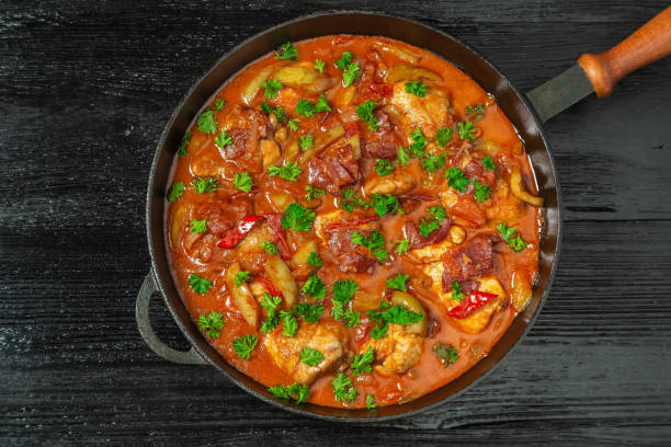 istock Chicken chilindron with thick vegetable sauce with red wine and dry-cured ham. The view from the top. Copy-space. 1052980164