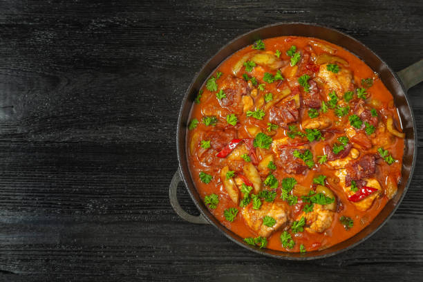 istock Chicken chilindron with thick vegetable sauce with red wine and dry-cured ham. The view from the top. Copy-space. 1052980202