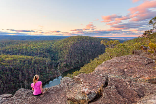 istock Cliff top views over mountains and river gorge after bush hike 1052983162