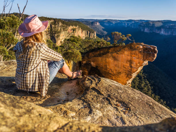 istock Female relaxes with spectacular mountain views after hike 1052984292