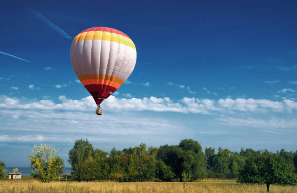 istock hot air balloon in blue cloudy sky 1052986238