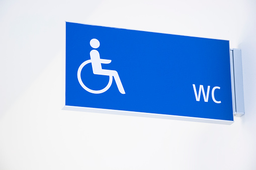 Wheelchair user icon on the blue toilet sign