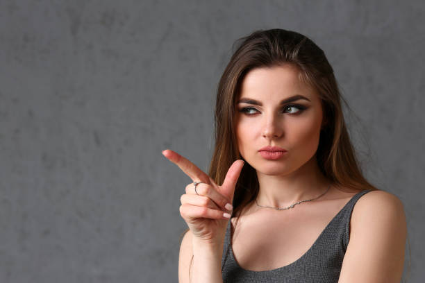 istock A caucasian woman on a gray background 1052987260