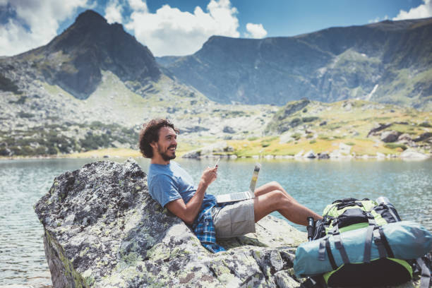 istock Young man surfing the net among nature 1052989172