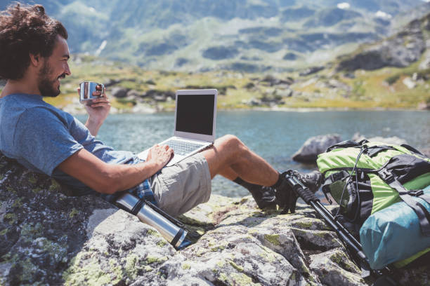 istock Young man surfing the net among nature 1052989202