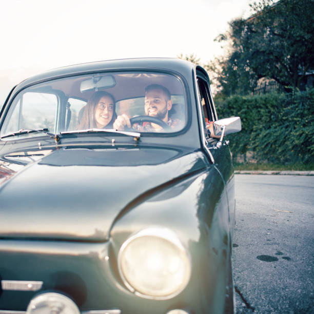 istock Joyful young couple smiling while riding in car 1052990662