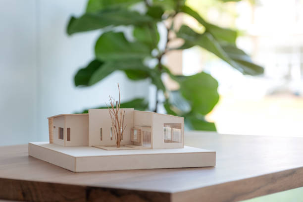 istock An architecture model on wooden table in office with blur nature background 1052993942