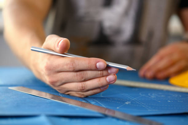 istock Male hand holding pencil in hand. 1052995624