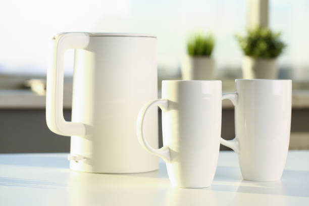 istock Teapot and two trendy cups are on the table for 1052995852