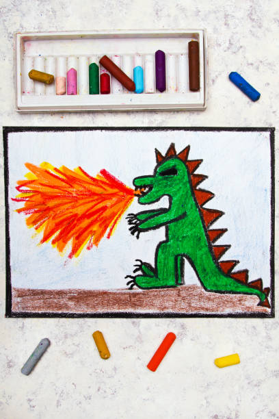 istock Colorful hand drawing: dragon spitting fire. Fire breathing dragon on paper. 1052995964