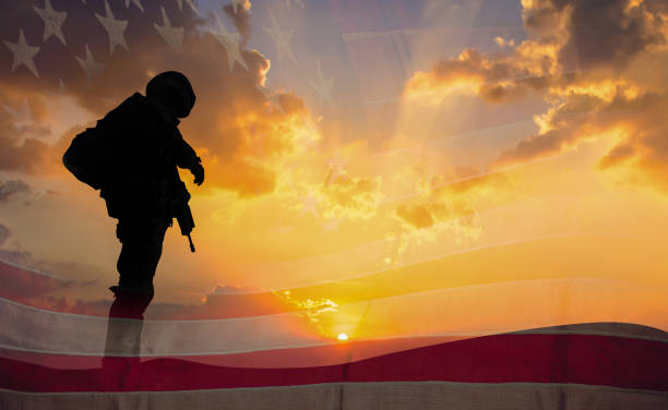doppelbelichtung silhouette der soldat auf der flagge der vereinigten staaten im sonnenuntergang für veteranen-tag ist eine offizielle usa feiertag hintergrund, textfreiraum. - national arms stock-fotos und bilder