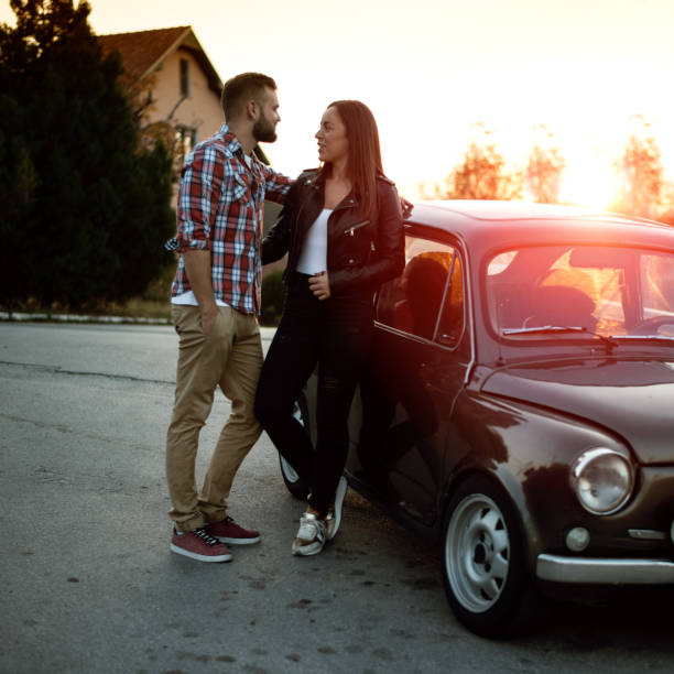 istock Couple hugging by car at sunset 1053001522