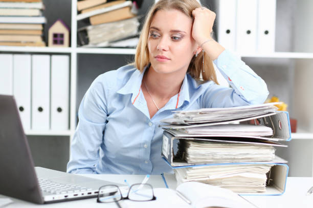 istock Lot of work wait for tired and exhausted woman 1053009366
