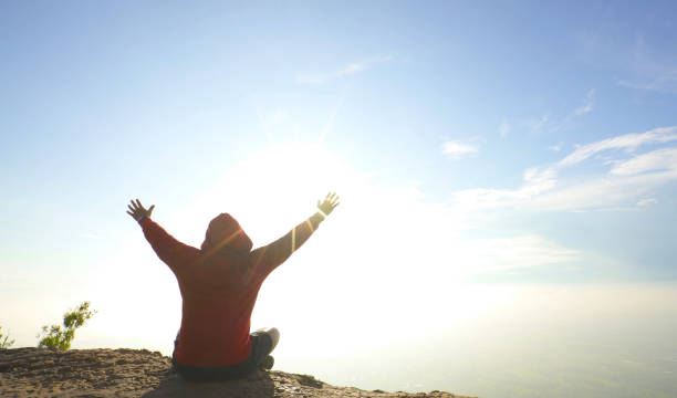istock Happy mansitting on mountain top sunny blue sky 1053010556