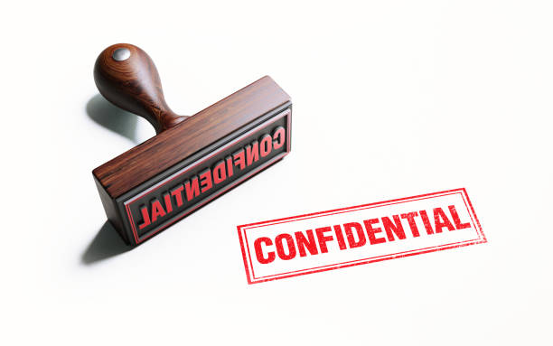istock Wooden Confidential Stamp On White Background 1053011802