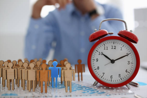 istock Businessman with his hand puts a miniature silhouette 1053017874