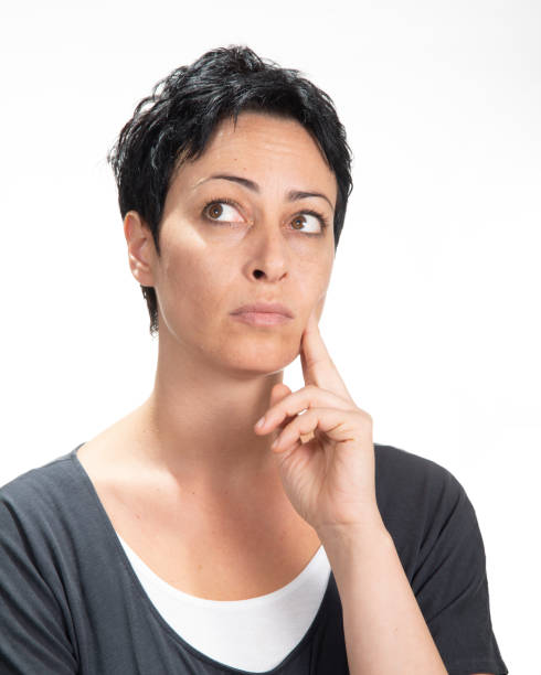 istock Beautiful woman isolated over a white background thinking on something 1053020428