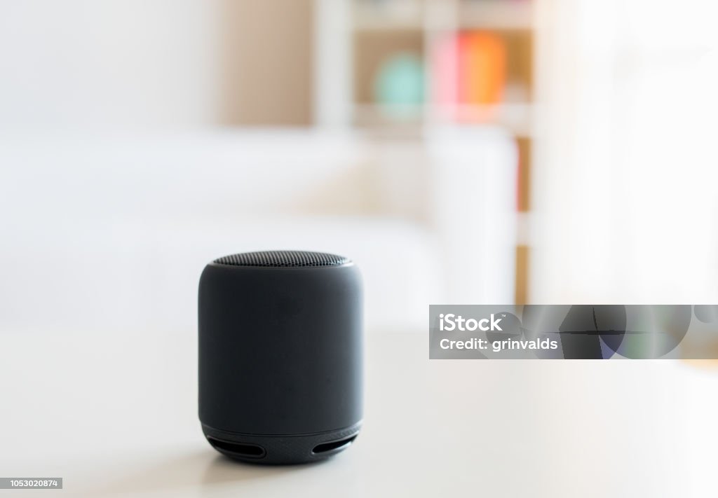 Smart speaker and virtual voice assistant at home Smart speaker and virtual voice assistant on a table in living room Speaker Stock Photo