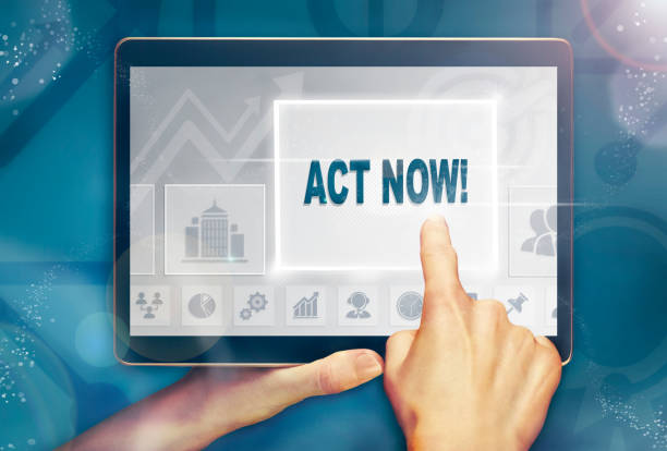istock A hand holding a computer tablet and pressing a act now concept. 1053022204