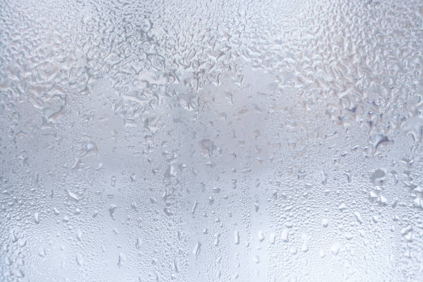 istock Thawed frosty drawing on the winter window as background or wallpaper. 1053023162