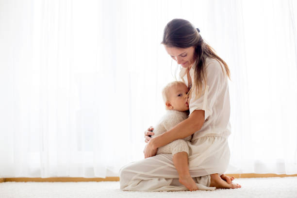 istock Young mother breastfeeding her toddler baby boy 1053025322