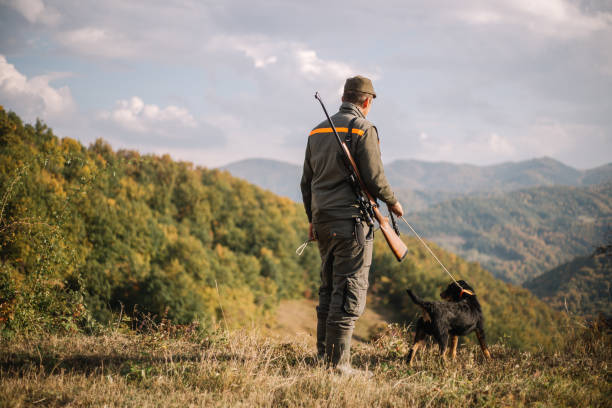 istock Hunter with a dog on the hunting grounds 1053027758