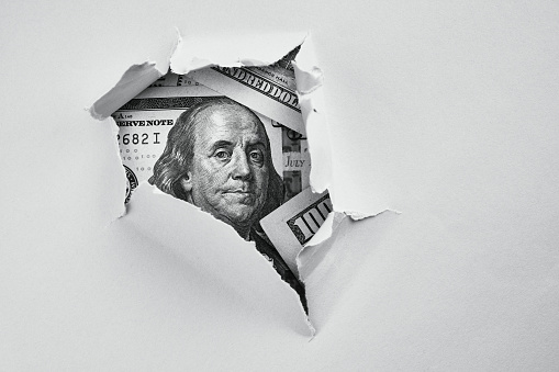 Dinero en papel agujereado photo