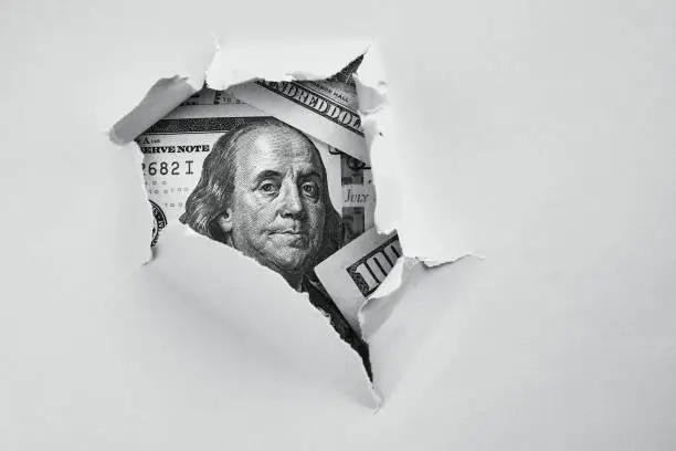 Photo of Money under holed paper