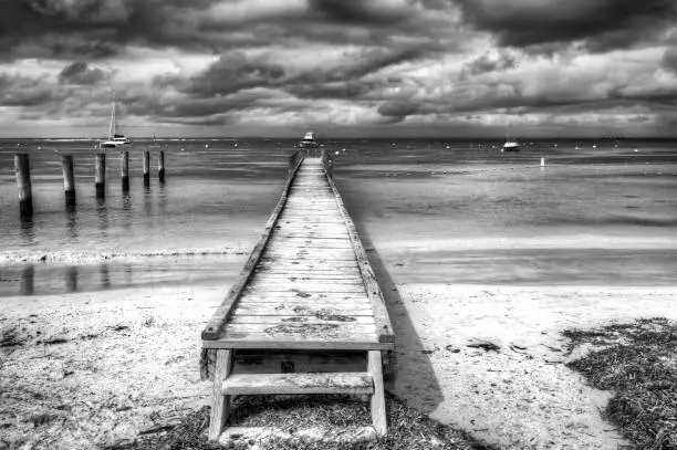 A wooden pier lonely under a stormy sky at rottnest island