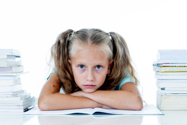 istock Frustrated little schoolgirl feeling a failure unable to concentrate in reading and writing difficulties learning problem attentional disorders special needs and low academic performance concept. 1053033206