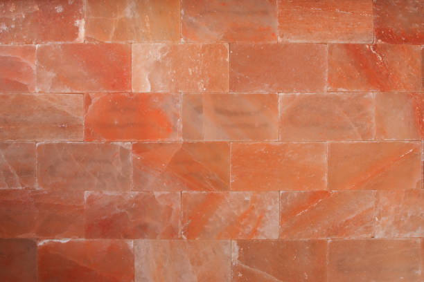 red himalaya salt bricks wall texture wallpaper background - pink salt imagens e fotografias de stock