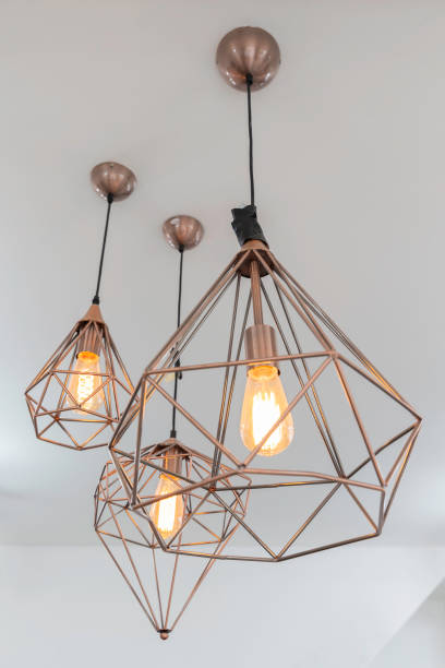 istock retro interior copper hanging lamp with orange light bulb. 1053034050