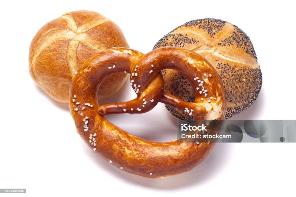 German bread and pretzel on white German bread rolls and a pretzel on a white surface Baked Stock Photo