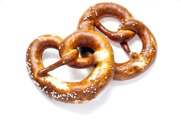 Two German bread pretzels on a white background