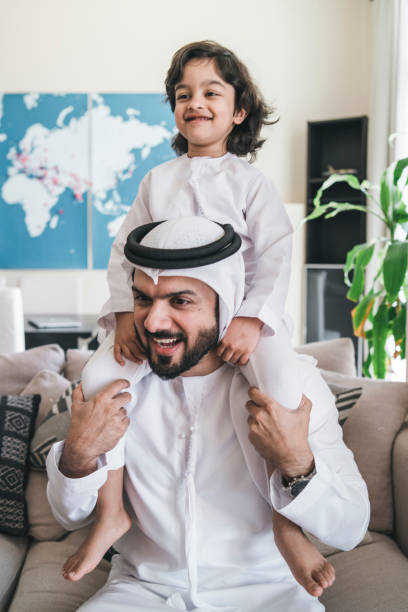 istock Arab man holding his son at home 1053037208