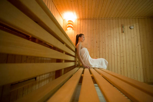 istock Young woman relaxing in a sauna 1053037246