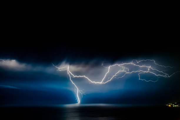 istock bright lightning that goes into depth of black sea, with branching branches in different directions, which illuminate the southern coast of Crimea and Yalta 1053040602