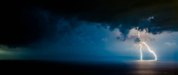 doppio fulmine luminoso che va in profondità nel mar nero, con rami ramificati in diverse direzioni, che illuminano la costa meridionale della crimea e yalta - ocean scenic flash foto e immagini stock