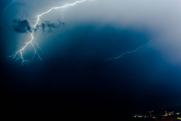 istock bright lightning that goes into depth of black sea, with branching branches in different directions, which illuminate the southern coast of Crimea and Yalta 1053040644