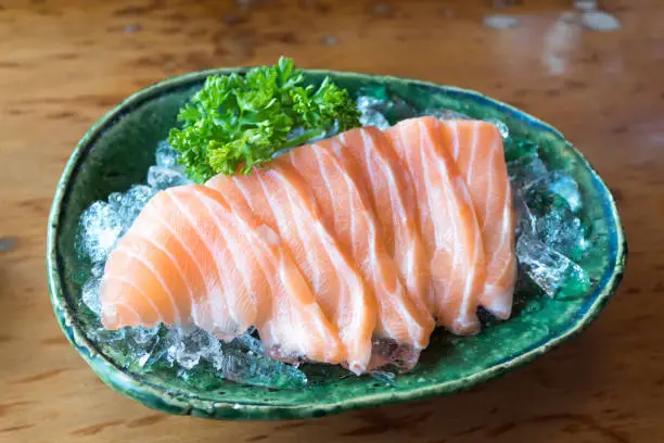 Close up of salmon, sashimi, japanese food on the ice bowl