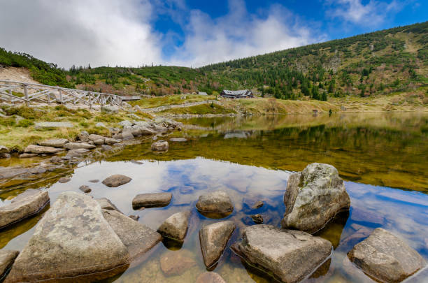 Shore of the Small Pond in Karkonosze (Giants Mountains) mountain range. 'Samotnia' mountain hut in the background. Poland, Lower Silesian province.