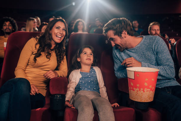 istock Young couple at cinema with a daughter 1053050838