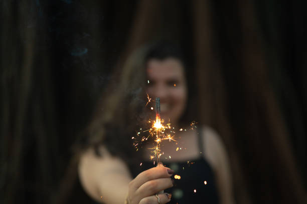 istock Happy Woman burning sparklers 1053053340